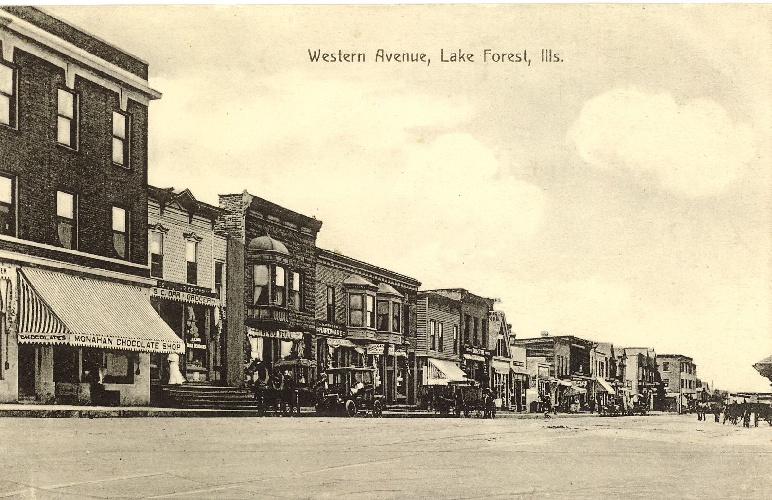 Looking northwest along Western Avenue, c. 1910. Monahan Chocolate Shop is at left – you can see the shop name on the awning of the three-story, brick Anderson building.