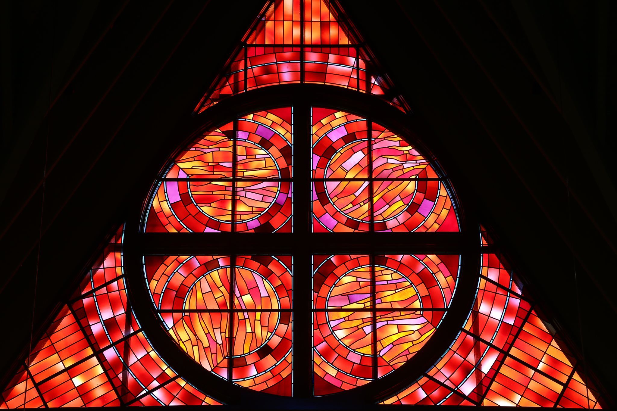 Brilliant colors and designs of a window in the sanctuary.