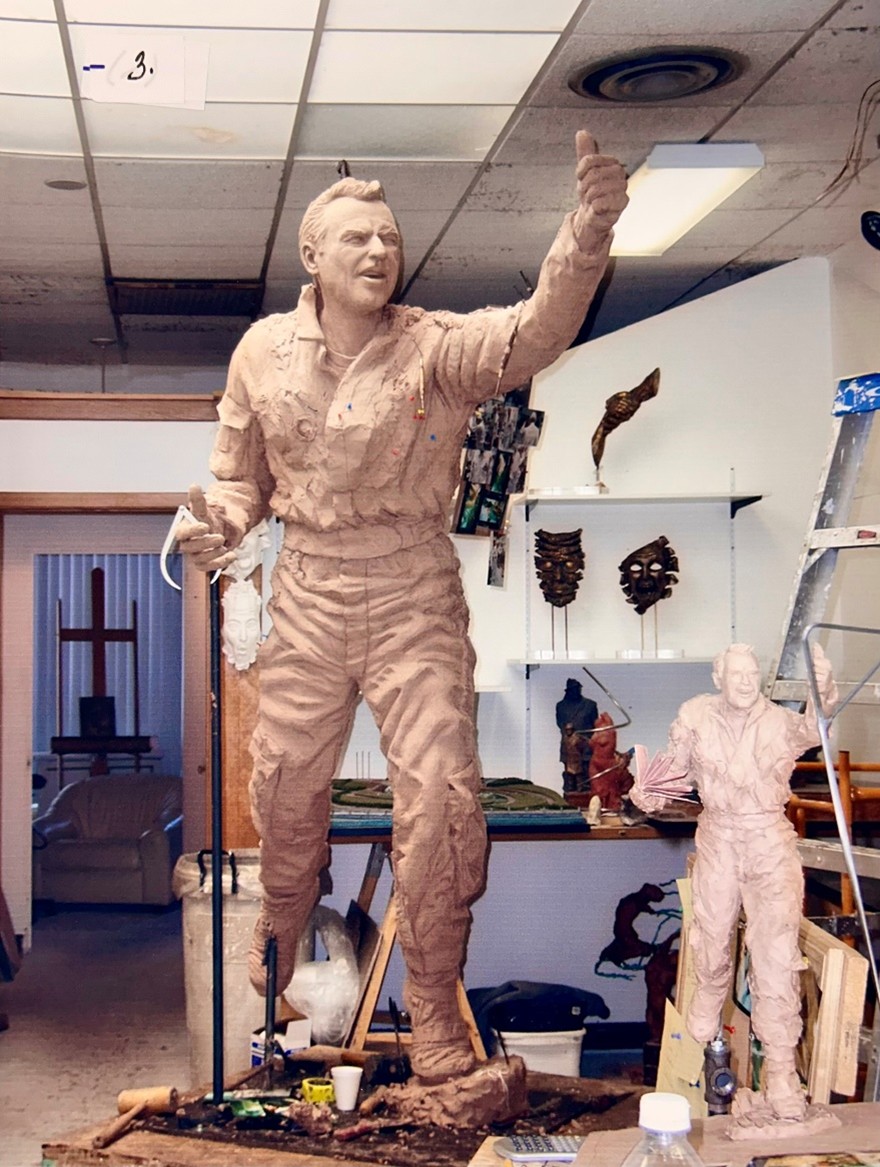 The sculpture grows in size and detail as the artists continue to shape the form