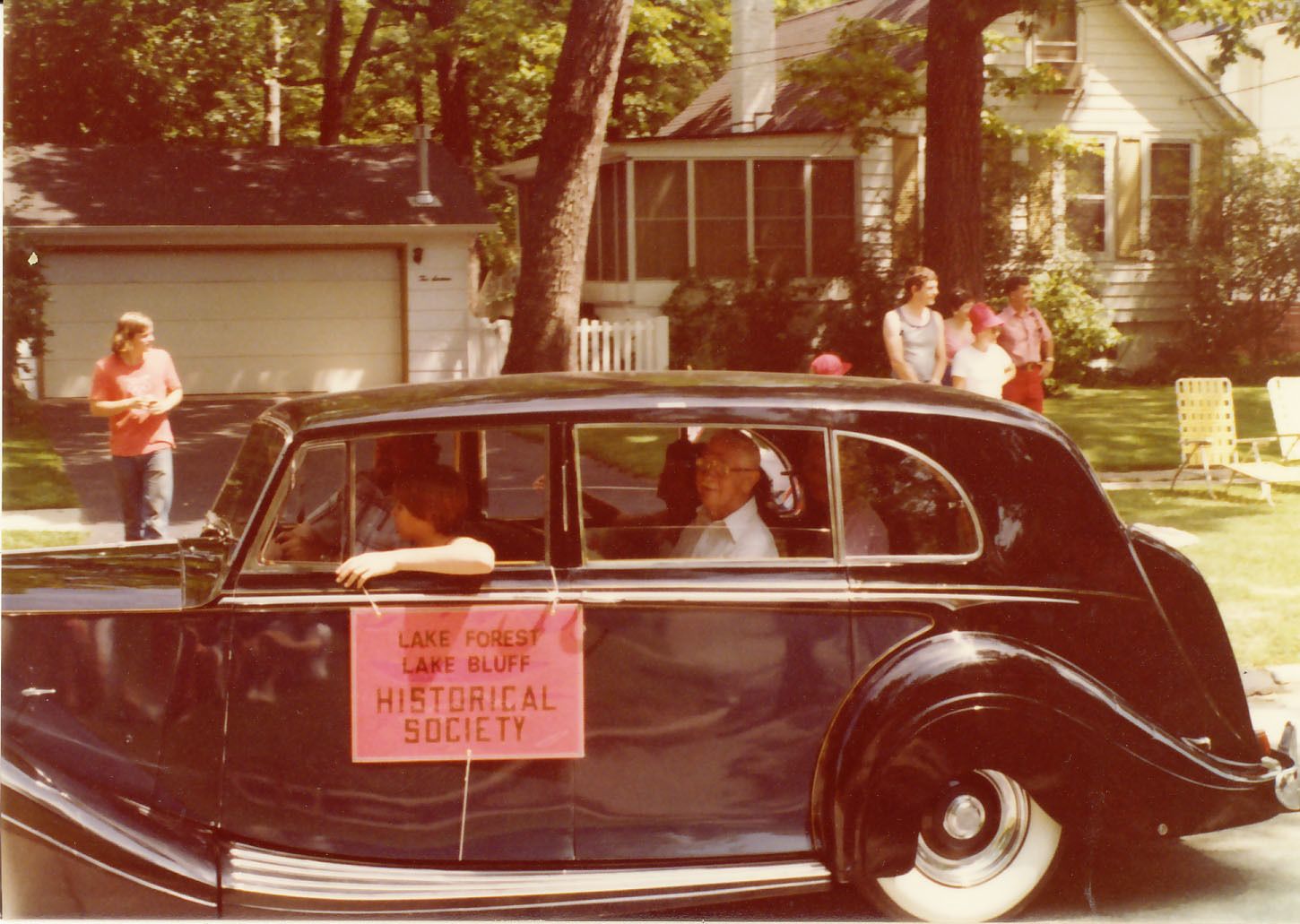 Elmer Vliet riding in the Lake Forest-Lake Bluff Historical Society car during the Lake Bluff Fourth of July Parade.